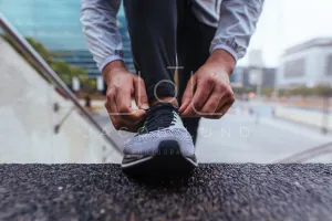 Close up of a man tying shoe lace